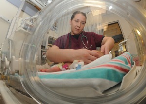 SAN DIEGO (March 4, 2011) Lt. Lauren Mattingly, an intern in the Naval Medical Center San Diego Graduate Medical Education program, examines a newborn baby in the Neonatal Intensive Care Unit.